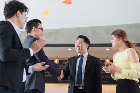 Business partnership meeting handshaking concept. Asian business people doing handshake. successful business people contract handshaking and clap hand after finished good business dealingの写真素材
