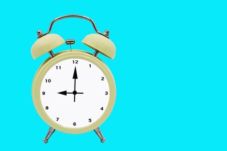 Cream colored alarm clock on a blue background
