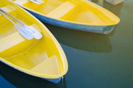 Yellow row boat on the lakeの写真素材