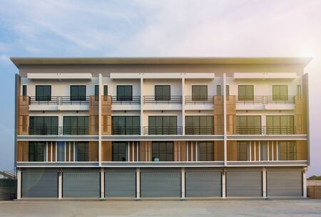 New houses, commercial buildings for sale or rent in the sky background Real estate concept, area of a new townhouse or condominiumの写真素材