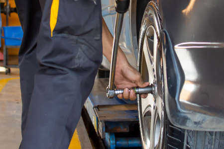 Technicians use tools to remove wheels at auto repair centers, Nonthaburi, Thailand, 10-05-2020.の写真素材