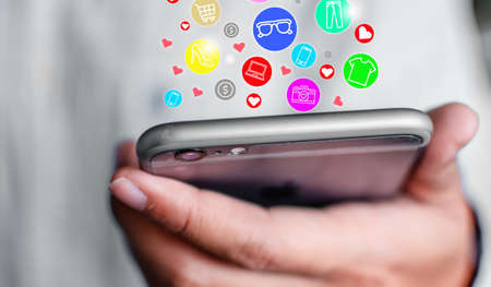 Icon showing online shopping symbol on mobile phone Concept of online shopping through the Internetの写真素材