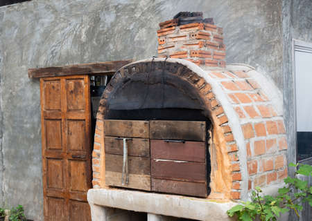 Brick oven uses charcoal for baking pizza.の写真素材