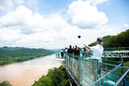 Tourists walk and take pictures on the sky walk, a beautiful new landmark on the Mekong. Chiang Khan...