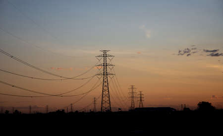 High voltage poles at sunset