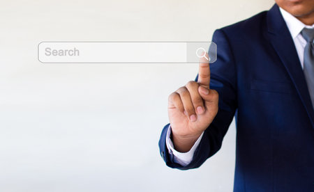 Businessman Searching for Information on Computer Screens: Conserve Using Technology to Find Informationの写真素材