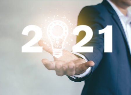 The numbers 2021 on the palm of businessmen Ideas to welcome business new year in 2021の写真素材