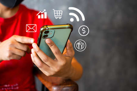 Icon surrounded by smartphone in hand Smartphone concept, Internet network, social networkの写真素材