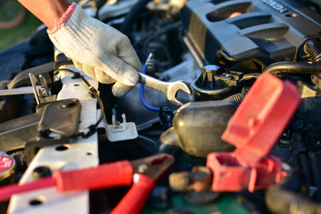 A wrench in the hands of a mechanic preparing to fix the machine of the car, fix the breakdown at the repair center.の写真素材