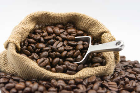 coffee and scoop in bag on white backgroundの写真素材