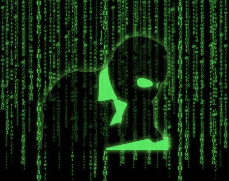 Computer hacker silhouette of hooded man on matrix backgroundの写真素材