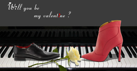 A shoe man and a women boots sitting on a pianoの写真素材