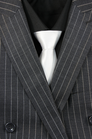 Detail of a striped black suit with white tieの写真素材