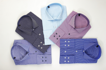 Some colored shirts arranged in a shape on white backgroundの写真素材