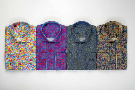 Some colored shirts arranged in a shape on white backgroundの写真素材