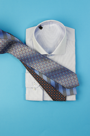 Men shirt and more neck ties on blue backgroundの写真素材