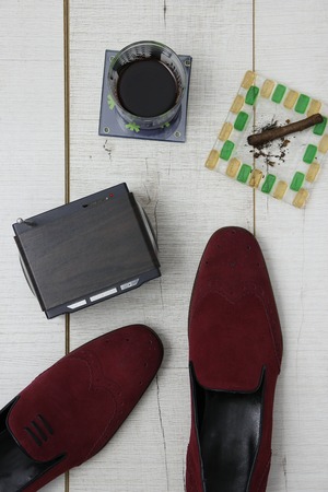 Men's leather shoes sitting on a wooden backgroundの写真素材
