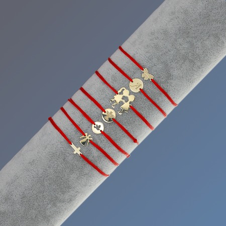 Gold charms on velvet roll on grey backgroundの写真素材