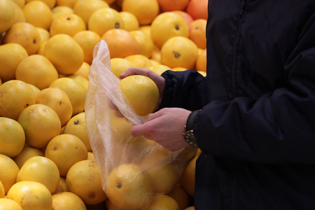 A seller who chooses fruits / vegetables in the supermarketの写真素材
