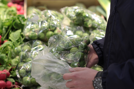A seller who chooses fruits / vegetables in the supermarketの写真素材