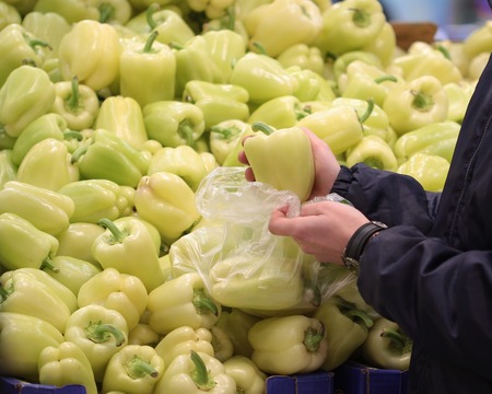 A seller who chooses fruits / vegetables in the supermarketの写真素材