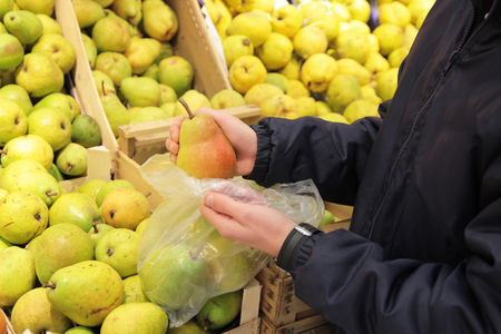 A seller who chooses fruits / vegetables in the supermarketの写真素材