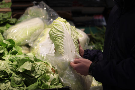A seller who chooses fruits / vegetables in the supermarketの写真素材