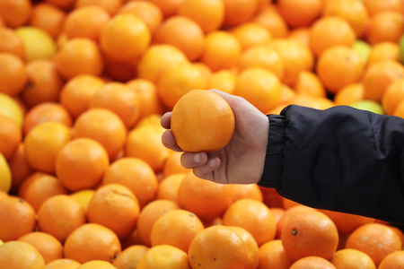 A seller who chooses fruits / vegetables in the supermarketの写真素材