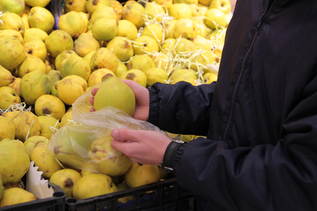 A seller who chooses fruits / vegetables in the supermarketの写真素材
