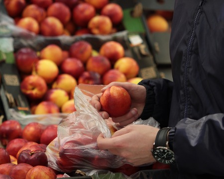 A seller who chooses a peach fruitの写真素材