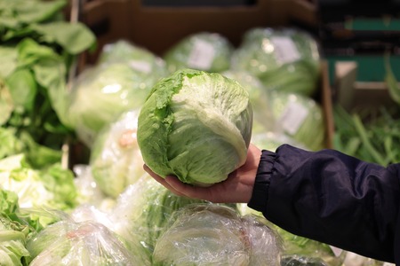 A seller who chooses fruits / vegetables in the supermarketの写真素材