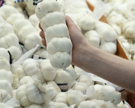 A seller who chooses a garlicの写真素材