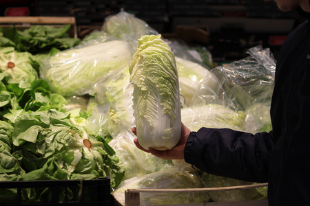 A seller who chooses fruits / vegetables in the supermarketの写真素材