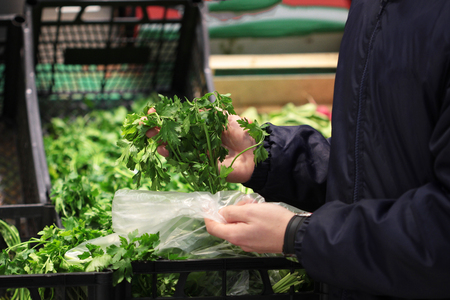 A seller who chooses parsley in the storeの写真素材