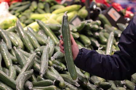 A seller who chooses vegetable in the storeの写真素材