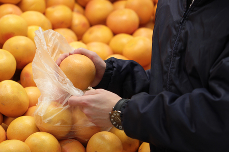 A seller who chooses fruits / vegetables in the supermarketの写真素材