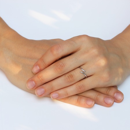 A woman's hand with silver rings and colored semi-precious stonesの写真素材