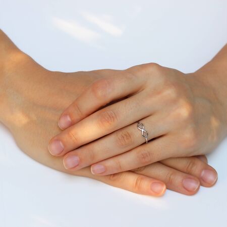 A woman's hand with silver rings and colored semi-precious stonesの写真素材