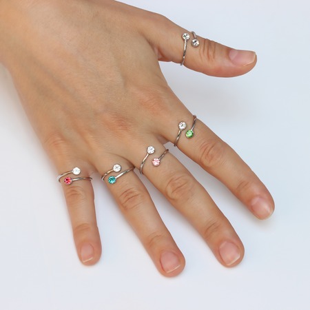 A woman's hand with silver rings and colored semi-precious stonesの写真素材