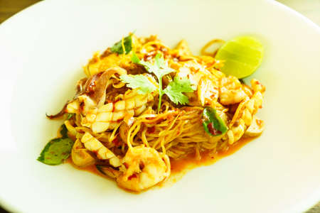 tasty thai dish of tom yum koong spaghetti mixの写真素材