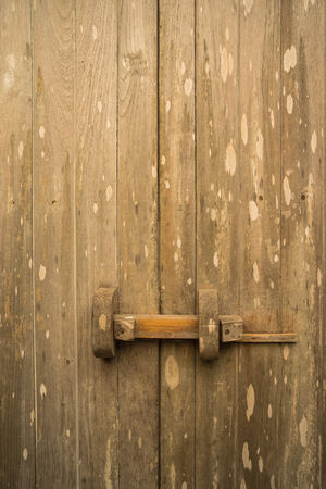 old teak wood door with traditional slide lockの写真素材