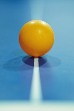 Image of a table tennis  ping pong  ball on center of table with leading line 