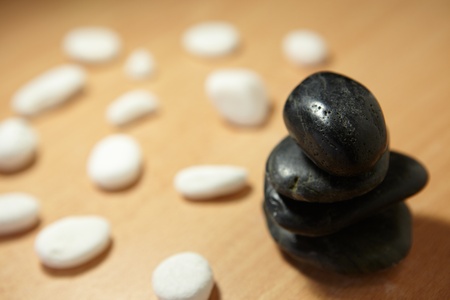 Spa massage still life   Balancing black stones and white pebblesの写真素材
