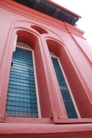 A wide angle view of a window frame on red buildingの写真素材