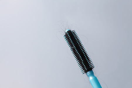 Hair brush with hair stuck in itの写真素材