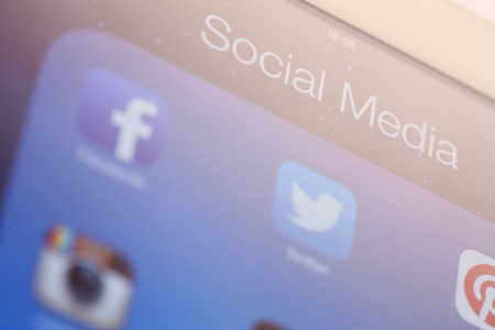 close-up of tablet with social media iconのeditorial素材