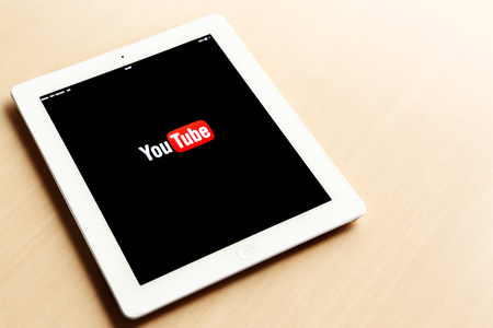 An Ipad tablet with YouTube application on screen lying on deskのeditorial素材