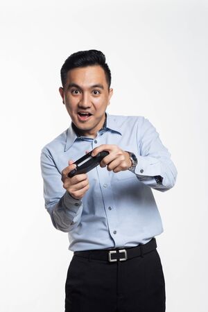 Asian man in work cloth playing console game