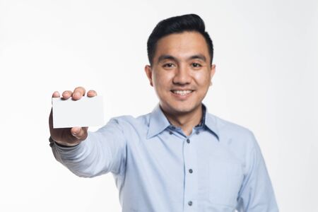 Asian man holding a blank card.の写真素材