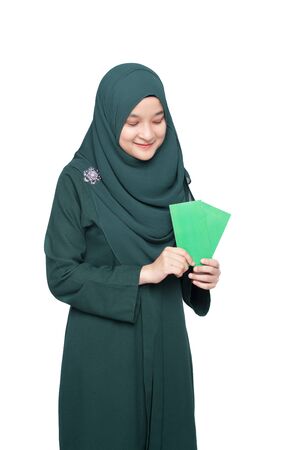 Malay woman holding green money packet.の写真素材